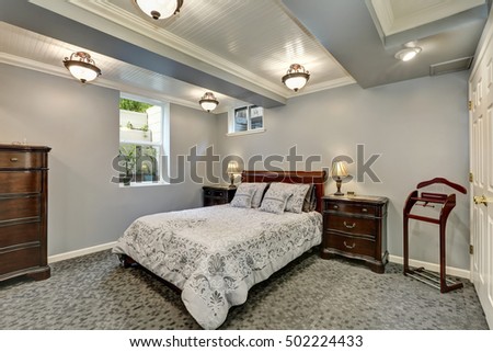 Gray bedroom interior downstairs with solid wood furniture. Northwest, USA