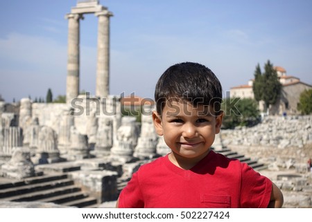 Portrait of smiling boy in the temple of Apollo.