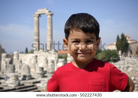 Portrait of smiling boy in the temple of Apollo.