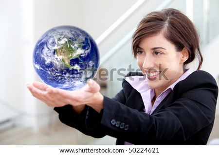 Business woman holding globe isolated over a white background