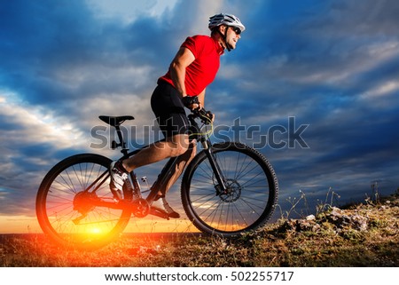 Mountain Bike cyclist riding single track outdoor with blue sky on background