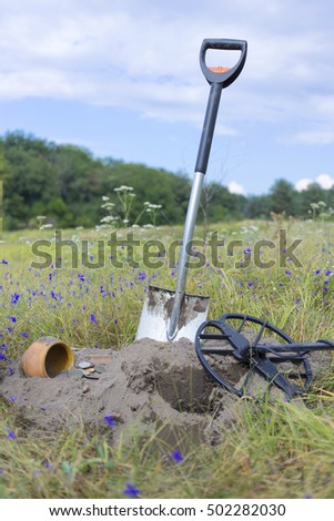 Search for treasure using a metal detector and shovel.