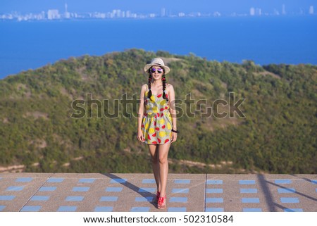 Carefree happy woman on view point on top of mountain edge cliff enjoying sun on her face.Enjoying nature sunset.Freedom.Enjoyment.Relaxing in mountains at sunrise.Sunshine.Daydreaming