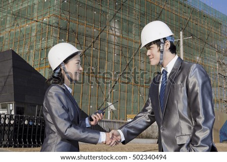 Engineers working at construction field 	