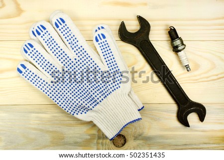 Open-end wrenches with the spark plug and protective gloves