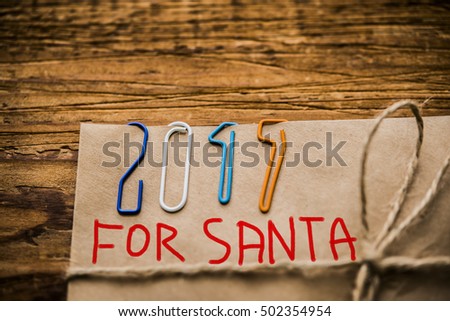 Christmas background. Happy new year 2017 - clips on paper envelope with rope lie on wooden table 