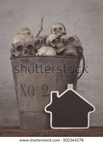 Still life with human skull in bucket on abstract background