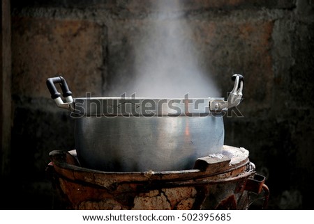 Old cooking pot stove using firewood. Royalty-Free Stock Photo #502395685