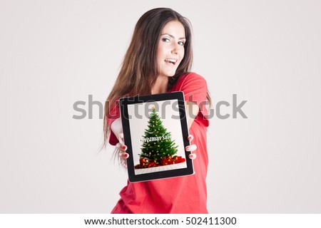  Beuatifull girl holding tablet computer with christmas sale on a screen