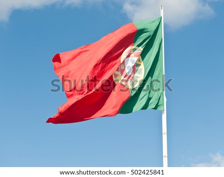 Flag of Portugal against blue sky