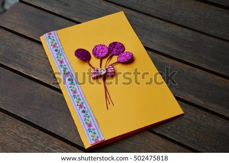 Yellow handmade paper card on a wooden table