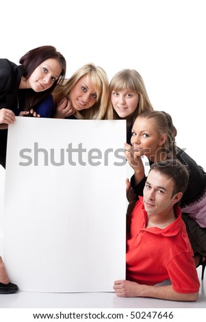 The group of young people holds the empty board for the text on a white background.