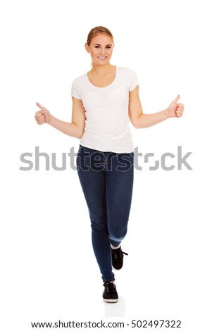 Young happy woman gesturing thumbs up