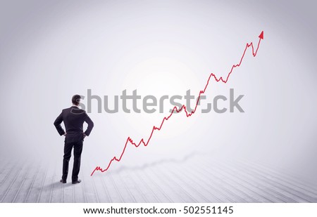 Elegant business person standing with his back looking at growing graph chart in space concept