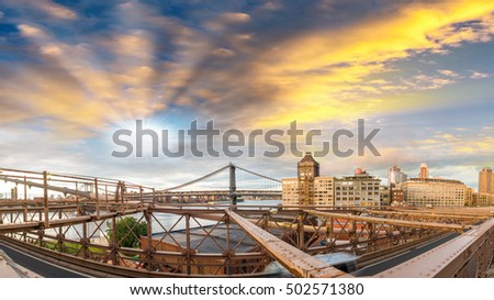Brooklyn Bridge structure and Brooklyn Buildings at dusk.