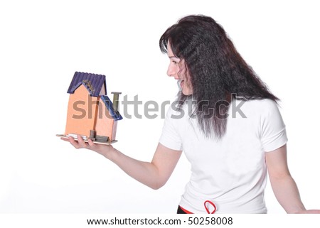 Happy young woman with little house in hand on white
