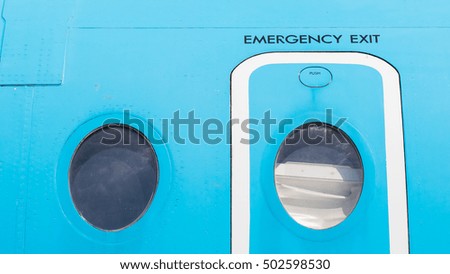 Windows of airplane with emergency exit door