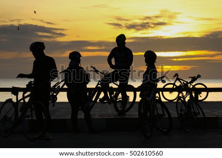 Silhouette of group in the morning at the Chalatut beach Songkhla and waiting for the sunrise 