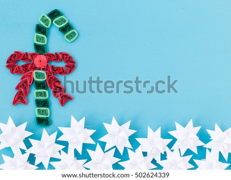 Christmas quiling decoration elements on blue board for background composition