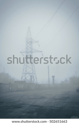 High-voltage pole in the mist