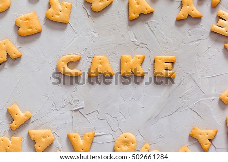 Letter cookies - CAKE a concrete background