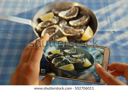 Take mobile photo of oysters