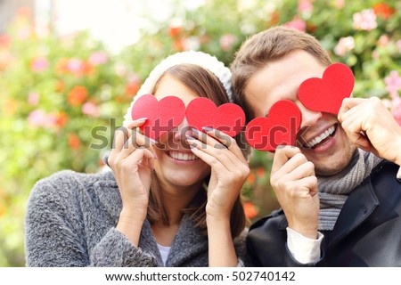 Picture of happy couple covering eyes with hearts