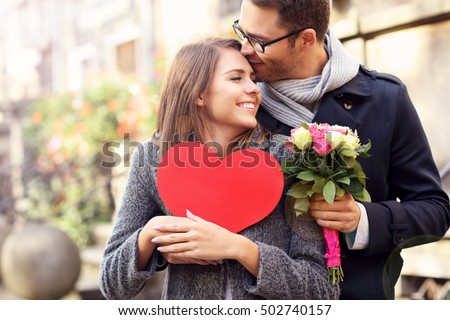 Picture of young couple with flowers and heart