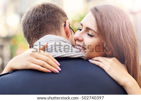 Picture showing happy couple hugging in the city
