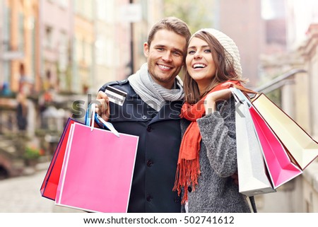 Picture showing young couple shopping in the city