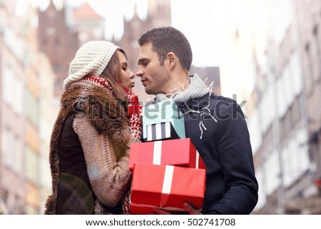 Picture showing young couple doing Christmas shopping in the city