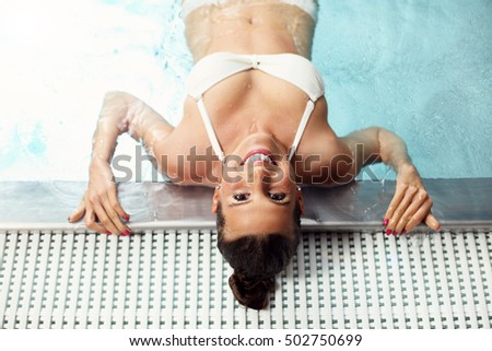 Picture of happy woman relaxing in pool spa