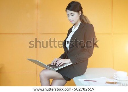 Portrait of a businesswoman working at office with laptop and document on table.