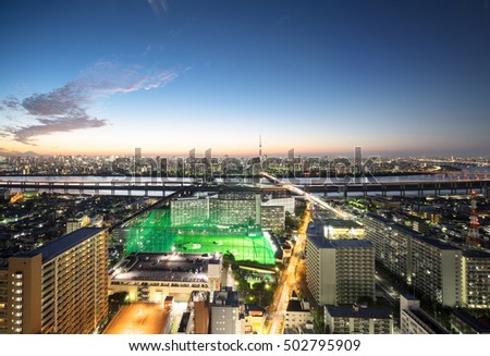 Business concept for real estate and corporate construction-panoramic modern city skyline bird eye aerial night view with tokyo skytree under dramatic glow and beautiful dark blue sky in Tokyo, Japan