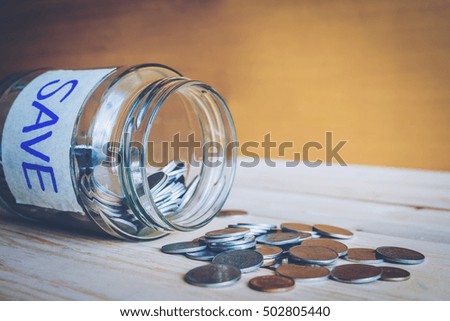 Saving money concept by coin in jar for growing business,house,or education.
