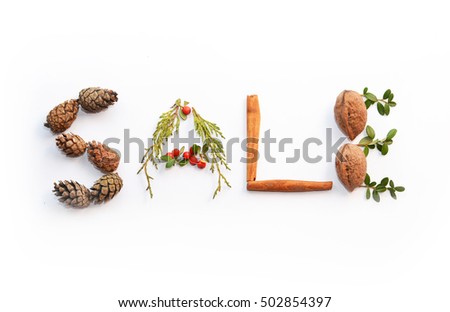 Sale concept made of colorful christmas staff : nuts, pine cones, cinnamon, star anise isolated over white, on white background. For christmas shopping, sales, advertising, discounts and promotion.
