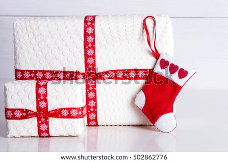 white gift box with polka dots and Santa's socks - Preparing for the New Year and Christmas