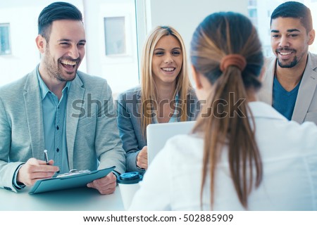 Job applicant having an interview.Group of business people having job interview with young woman. Royalty-Free Stock Photo #502885909