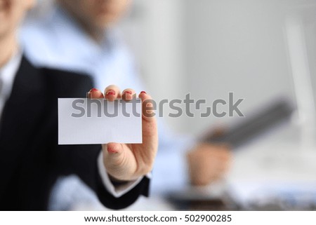 Woman hand giving business card in office.
