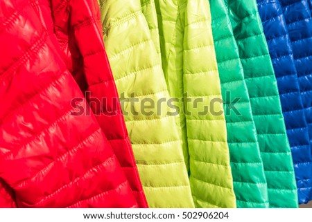 Bright winter clothes hanging at a fashion store