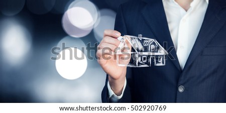 close up of business man holding small house in his hands
