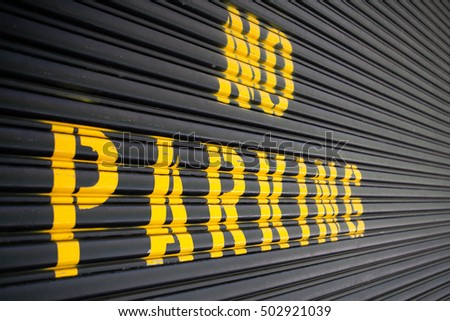 Steel roller garage door with the inscription No Parking