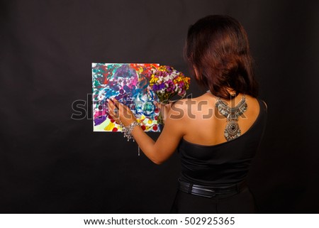 beautiful girl with a picture of the artist