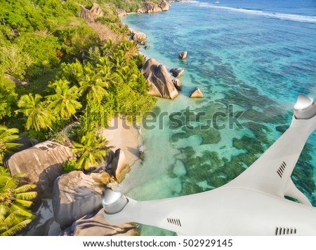 Drone flying above tropical beach on Seychelles