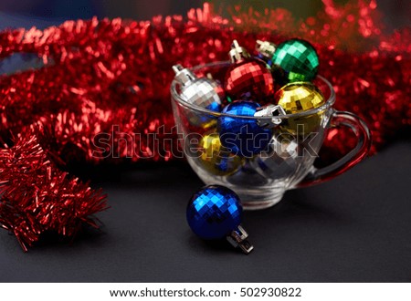 New Year's decor. The concept of the New Year holiday. Christmas decor. 2017. New Year's drink.New Year's toys in a transparent cup. Christmas background.