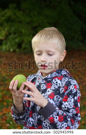 boy holding a pear