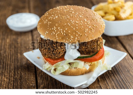 Fresh madeFalafel Burger on wooden background (close-up shot; selective focus)
