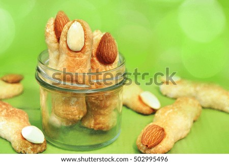 Witch finger cookies on bokeh background for Halloween, selective focus, toned

