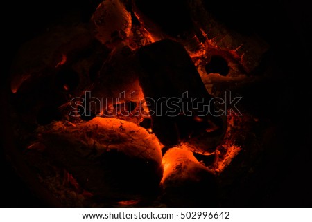 burning charcoal in the background