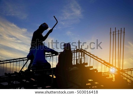 Silhouette of construction worker during sunset